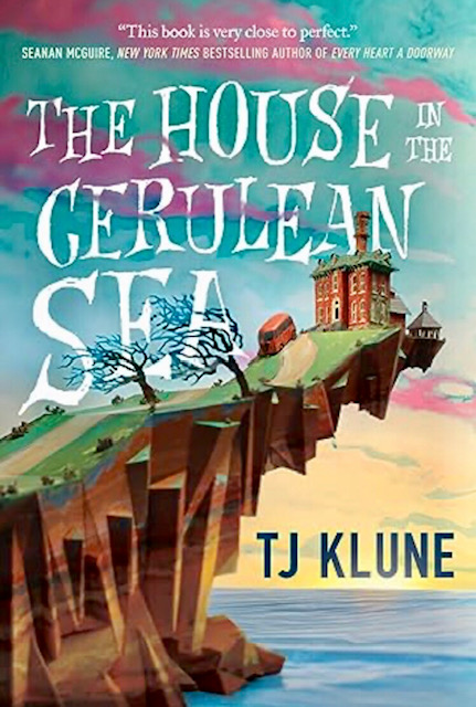 An image of the cover for House in the Cerulean Sea. A grand manor house sits at the edge of a large cliff overlooking the sea and rising sun.